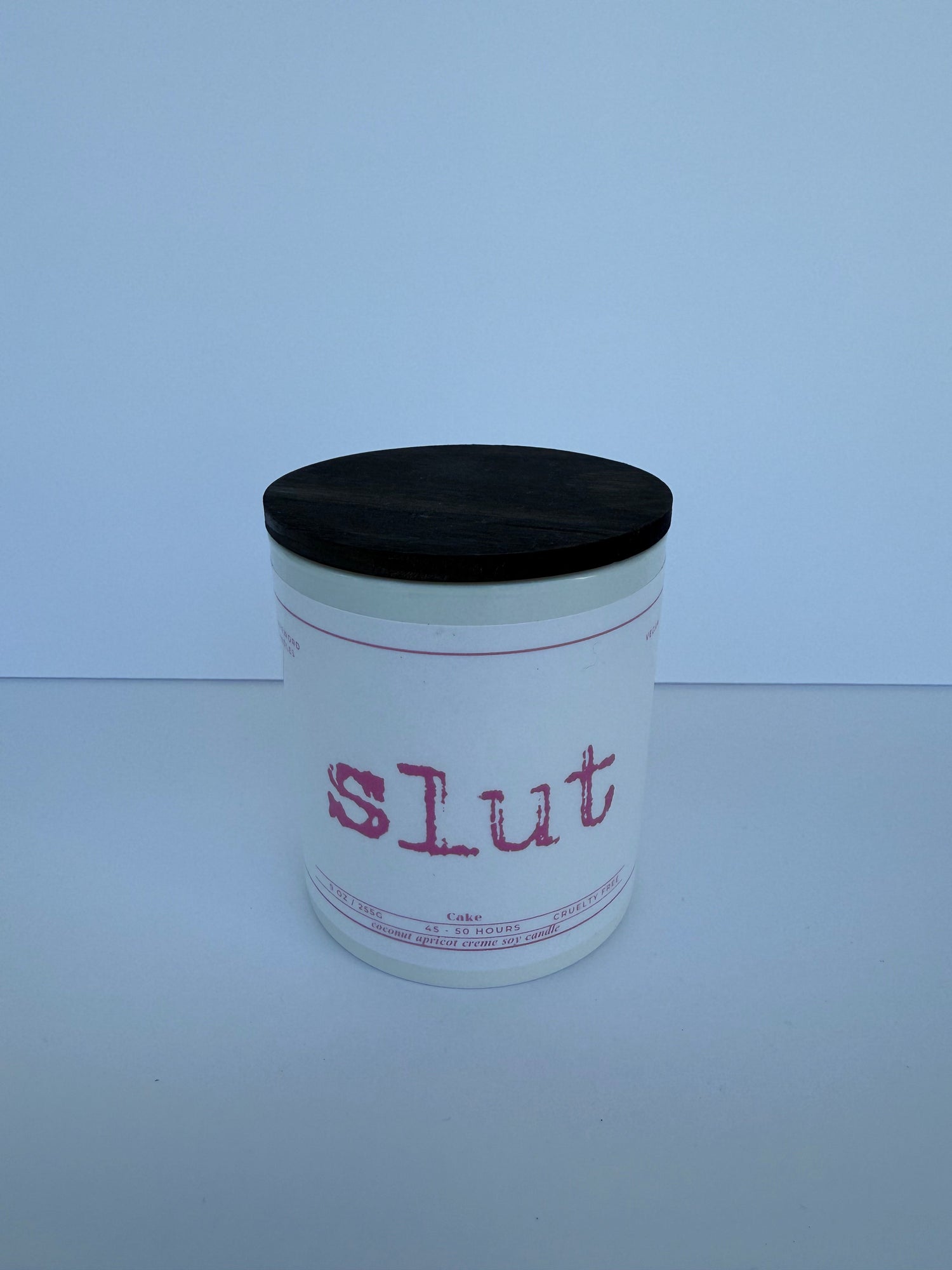 pink font slut candle on white jar